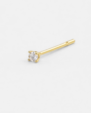 Gold stud earring with a clear gemstone on a white background