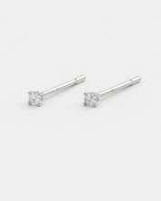 Silver stud earrings with clear gemstones on a white background