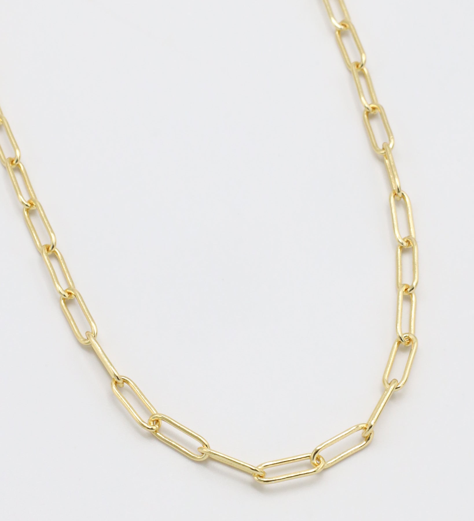 Gold chain necklace on a white background