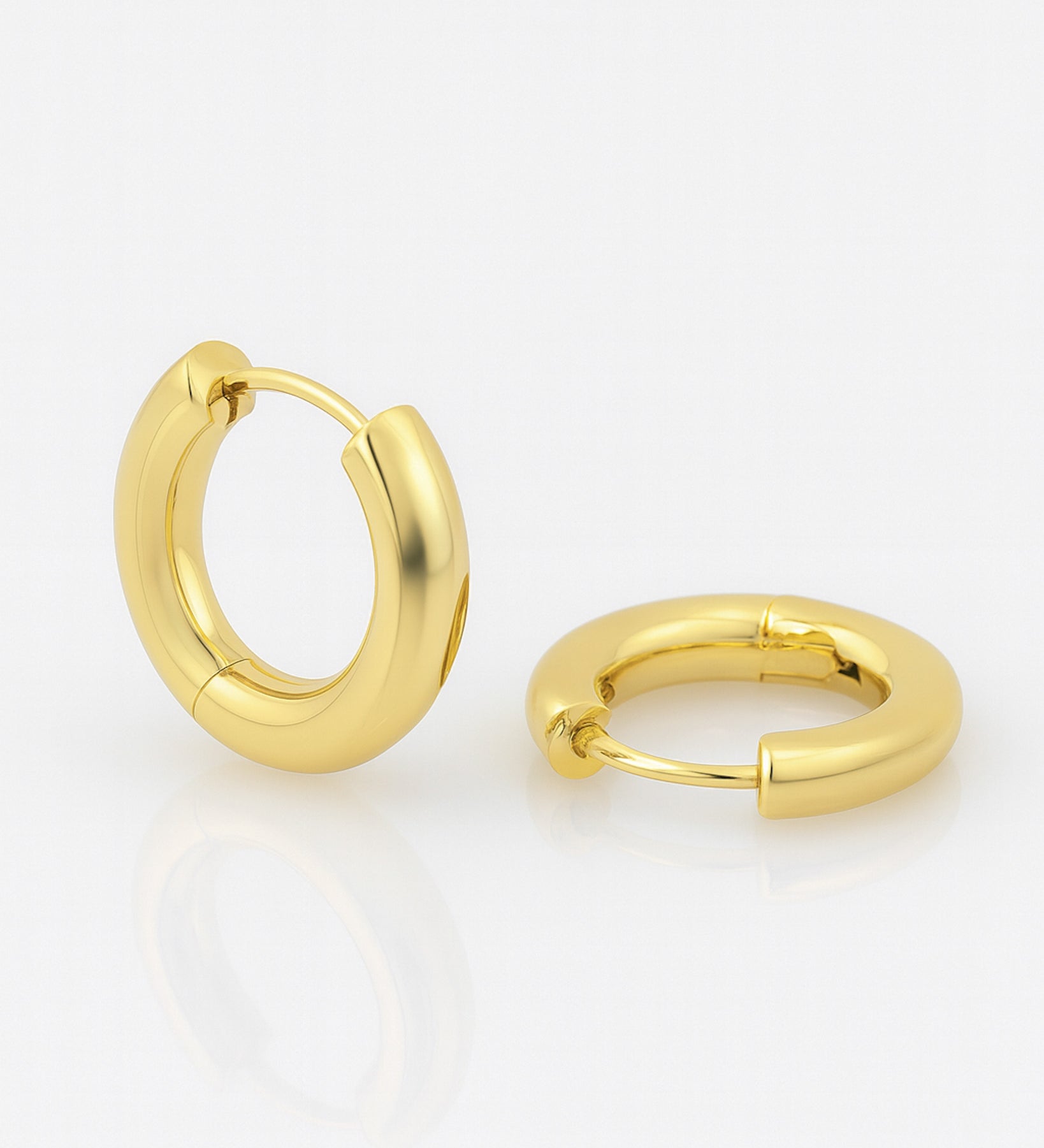 Gold hoop earrings on a white background