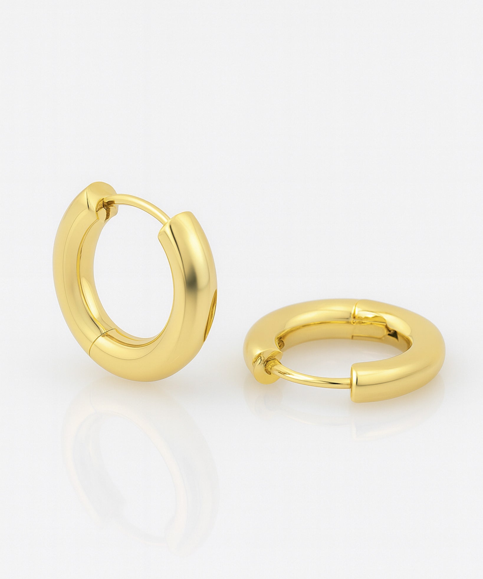 Gold hoop earrings on a white background