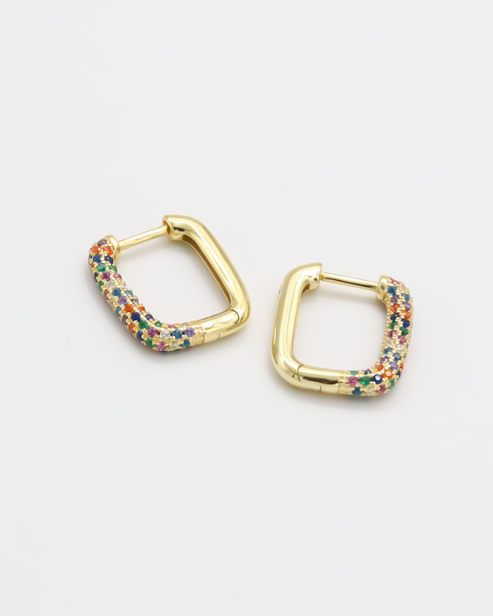 A single multicolor gold hoop earring with a hinged clasp, displayed against a white background.