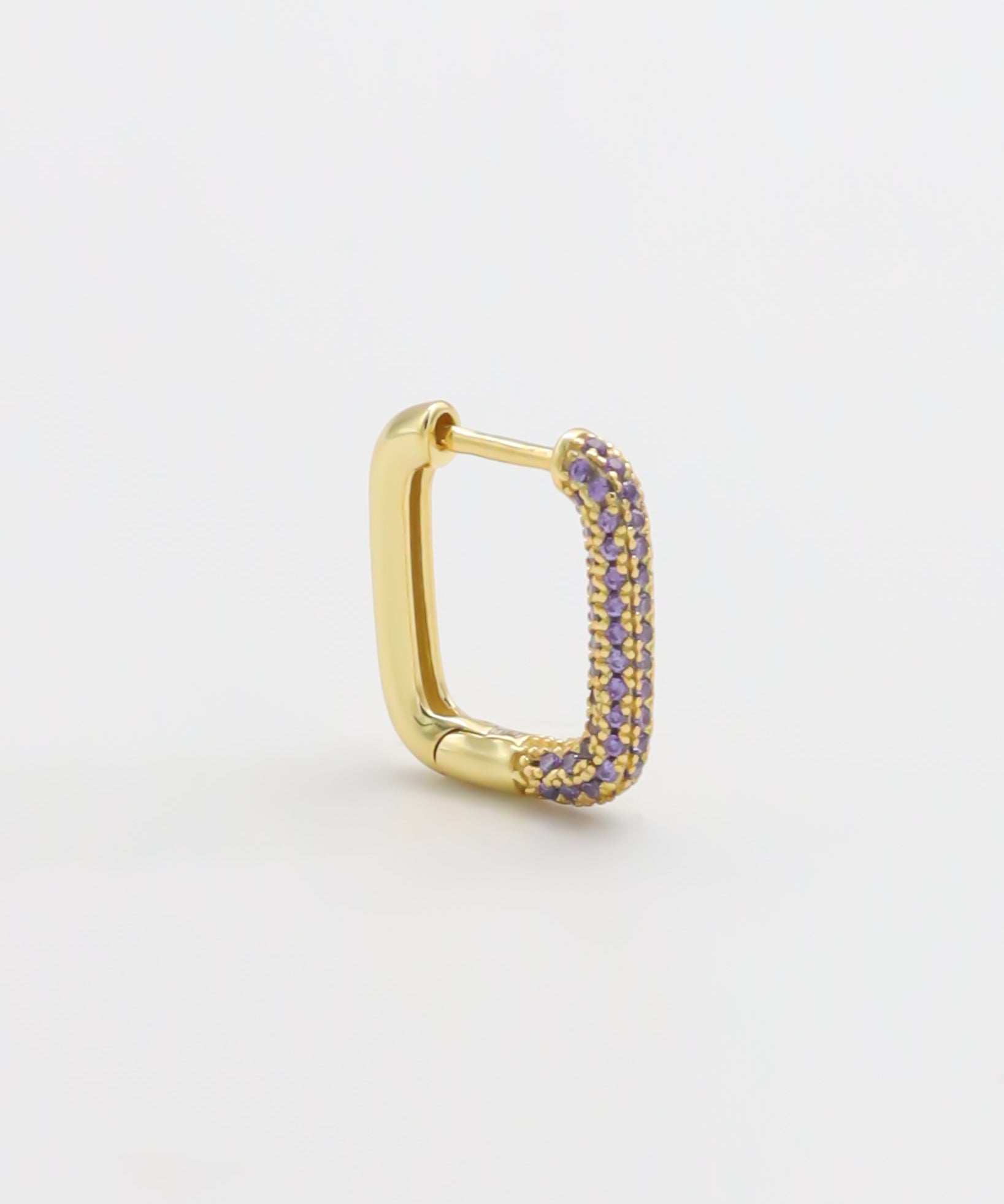 A single gold-colored hoop earring with purple accents, presented against a white background.