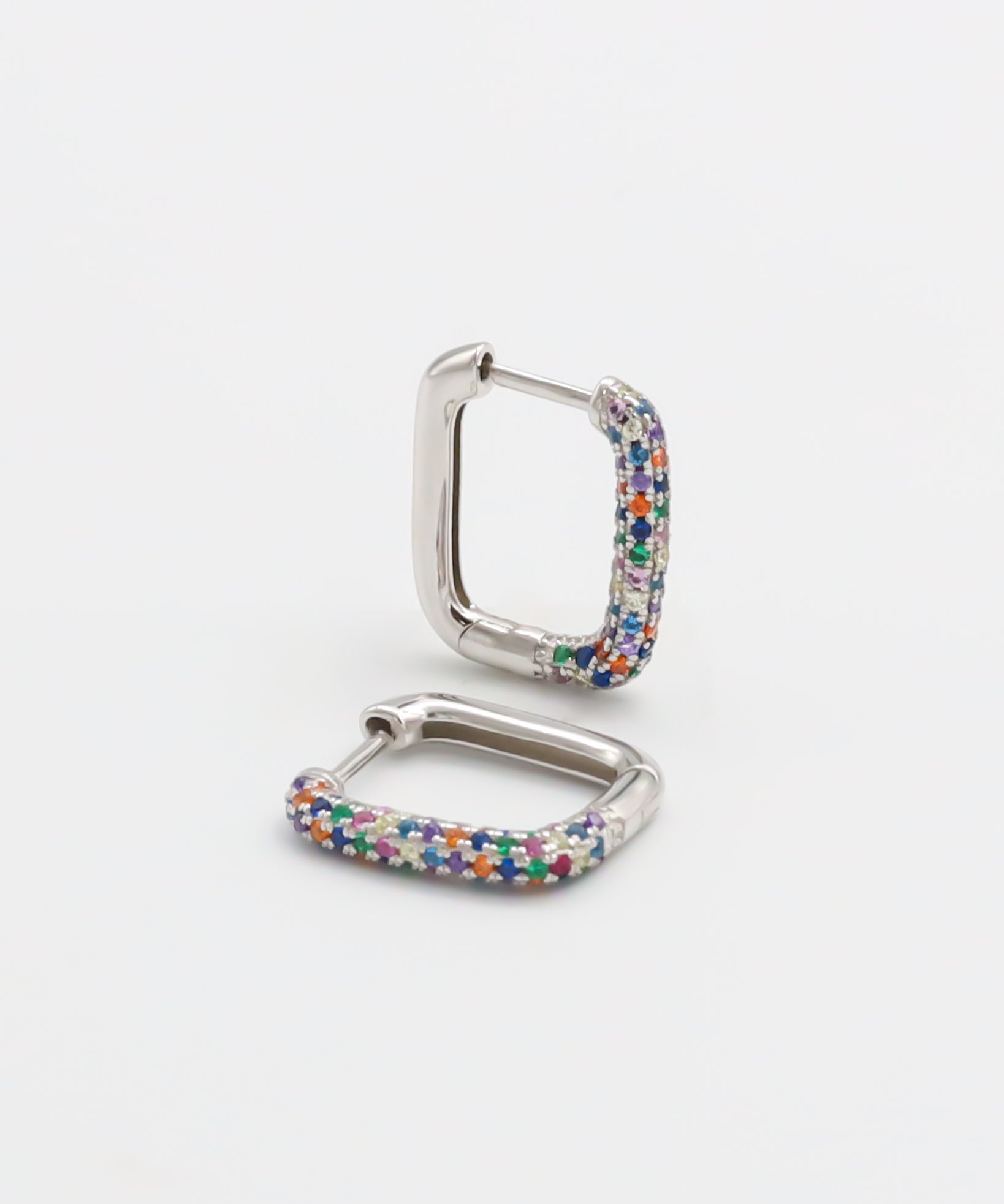 A multicolor silver hoop earring with a hinged clasp, against a white background.