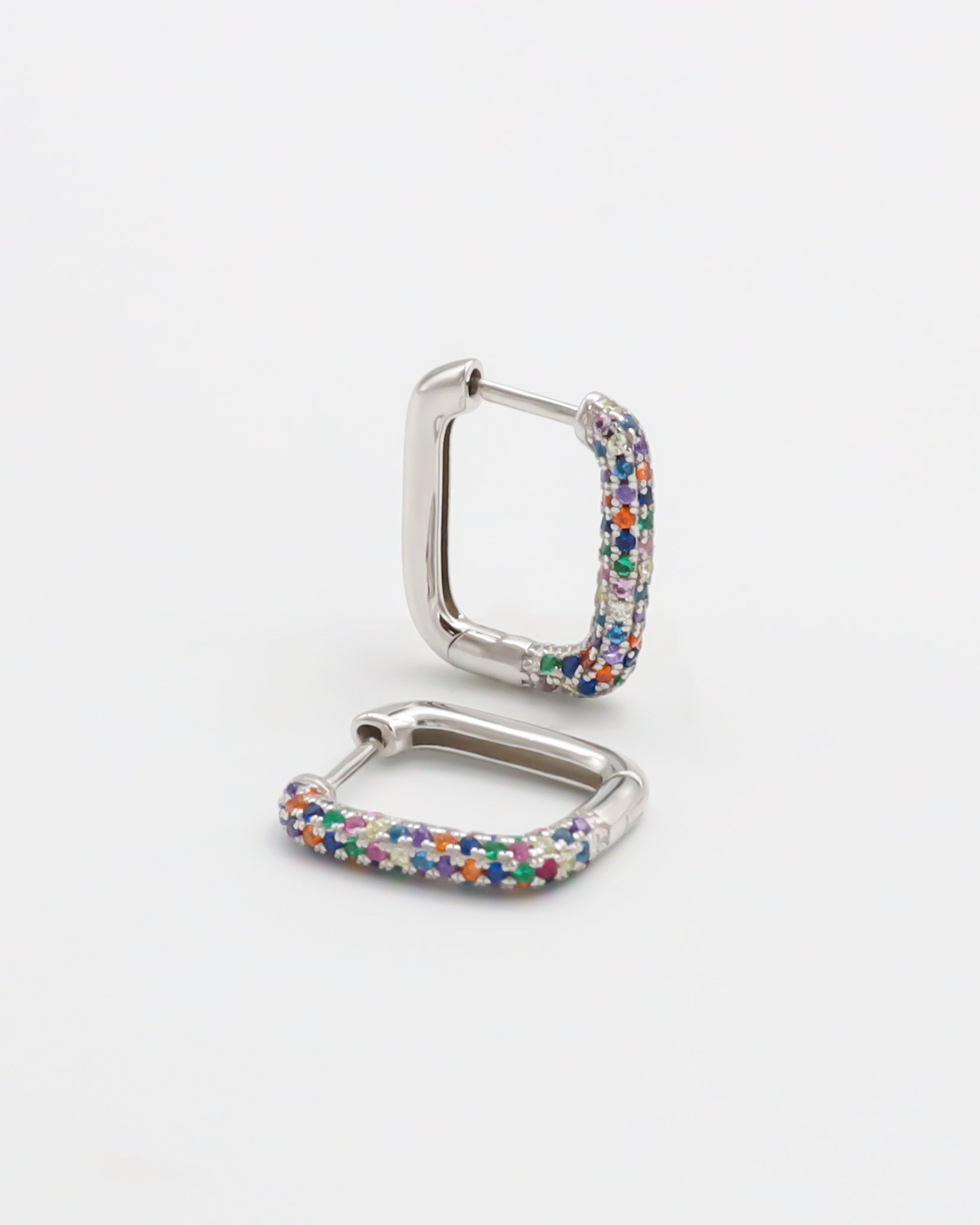 A multicolor silver hoop earring with a hinged clasp, against a white background.