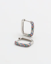 A multicolor silver hoop earring with a hinged clasp, against a white background.