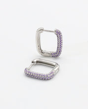 A single silver hoop earring with a hinged clasp and purple gemstone detailing.