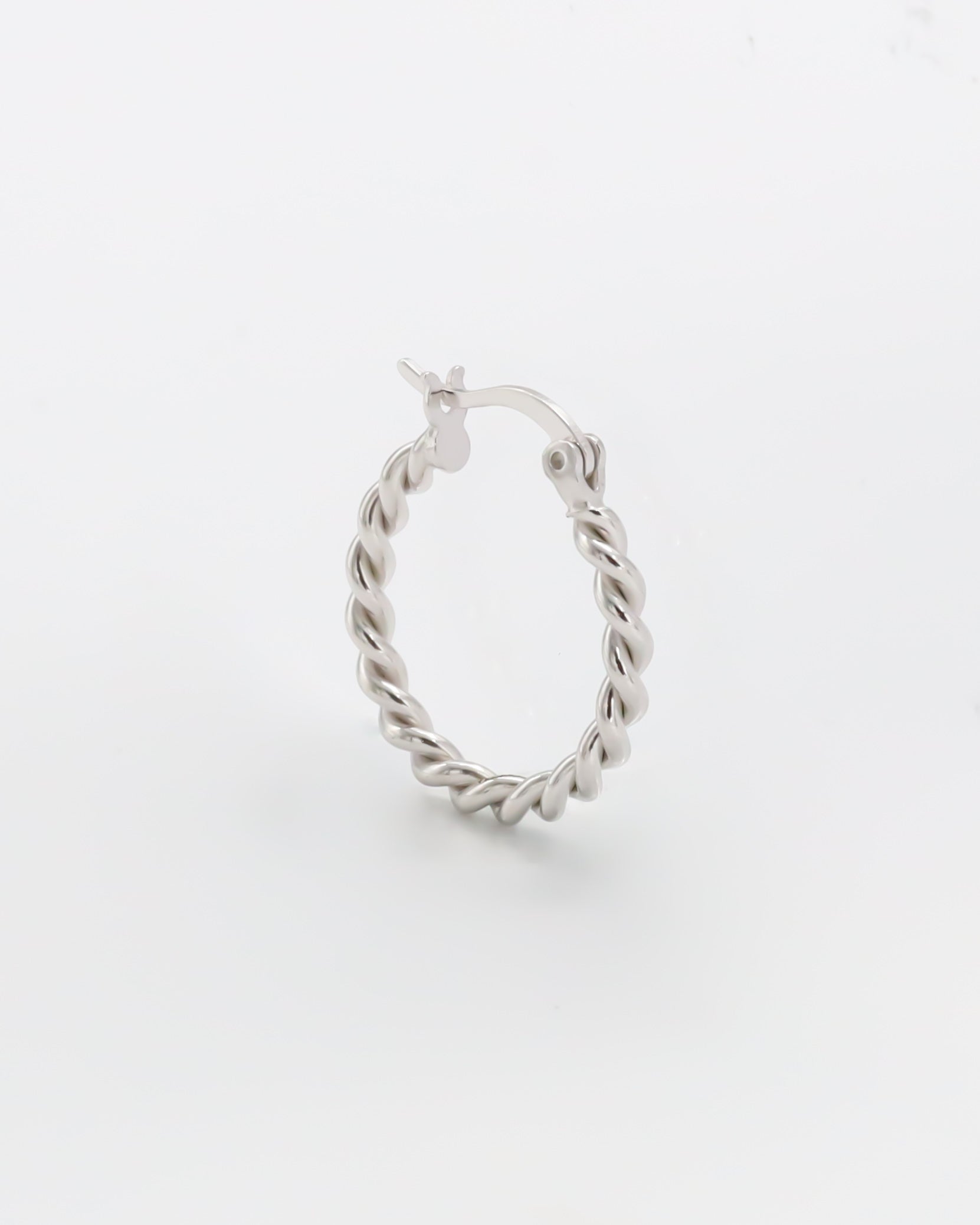 A single silver hoop earring with a twist pattern and latch back clasps on a white background.