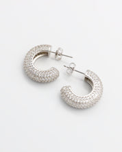 A pair of silver hoop earrings with a butterfly clasp closure.