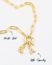 Gold-plated 925 sterling silver Croissant pendant styled with a Hunter Gold necklace and a Letter Sparkly pendant.