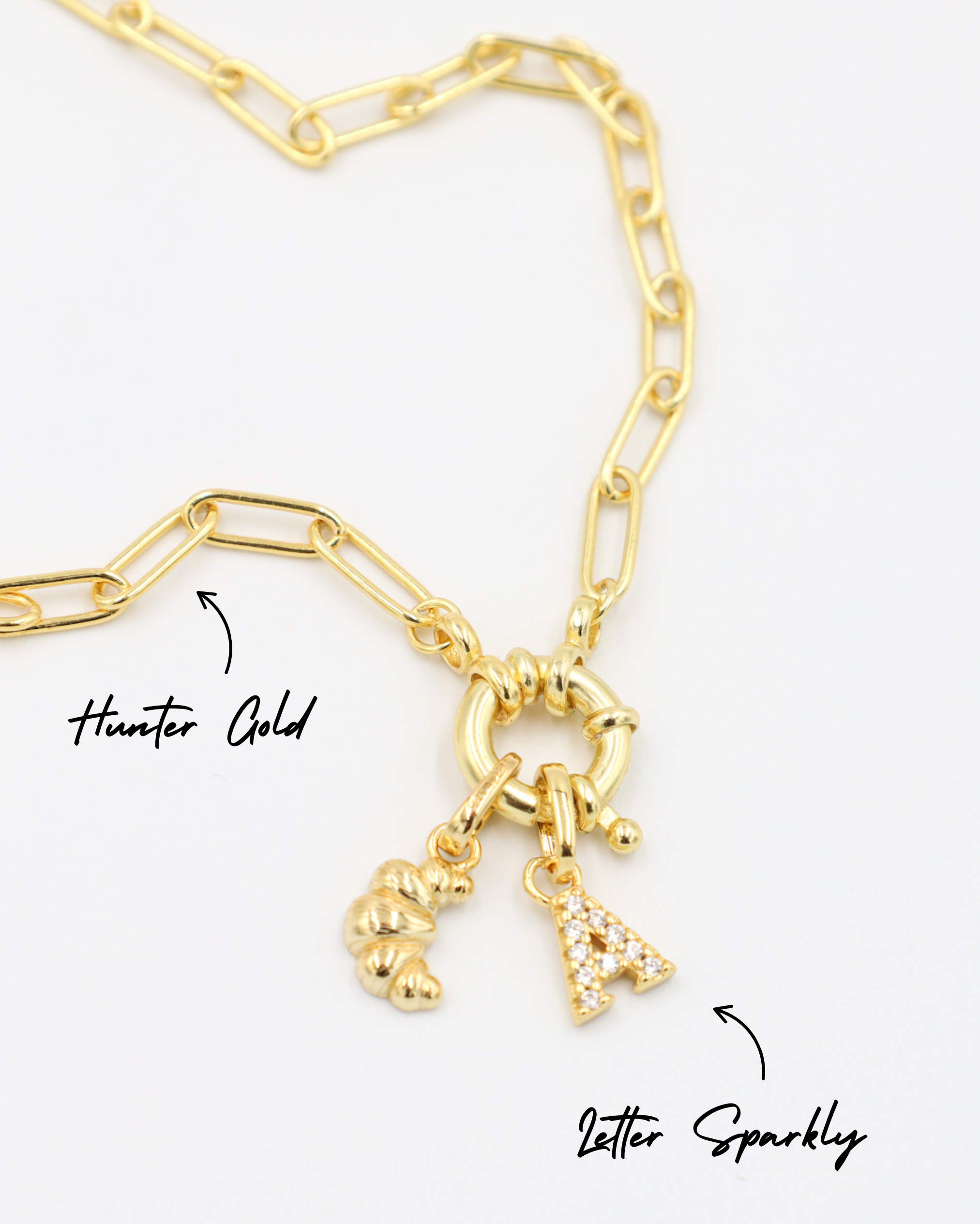 Gold-plated 925 sterling silver Croissant pendant styled with a Hunter Gold necklace and a Letter Sparkly pendant.