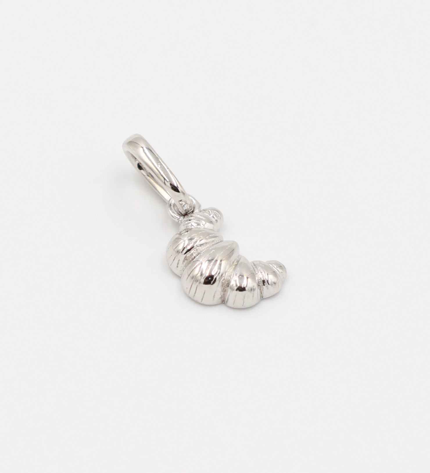 Croissant Silver pendant made from rhodium-plated 925 sterling silver, laid flat to display the details.