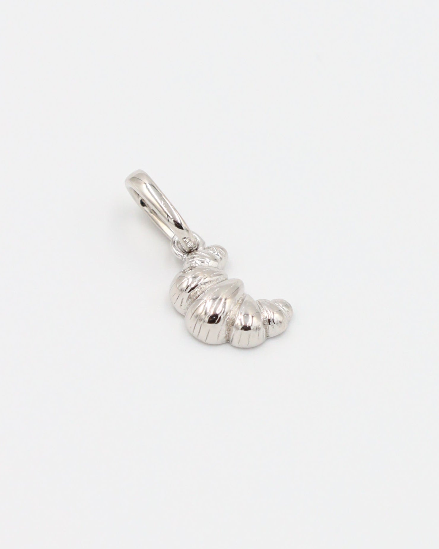 Croissant Silver pendant made from rhodium-plated 925 sterling silver, laid flat to display the details.