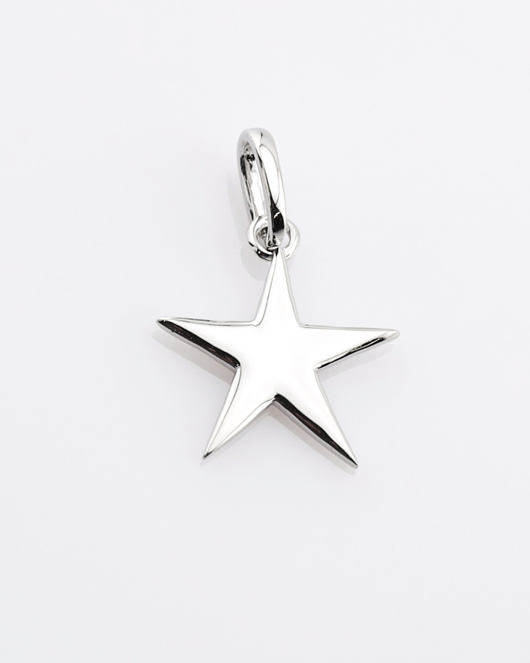 Silver star-shaped pendant on a white background