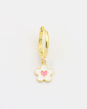 A gold-colored hoop earring with a white and gold flower-shaped charm attached to it.
