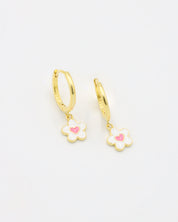 A gold-colored hoop earring with a white and gold flower-shaped charm attached to it.