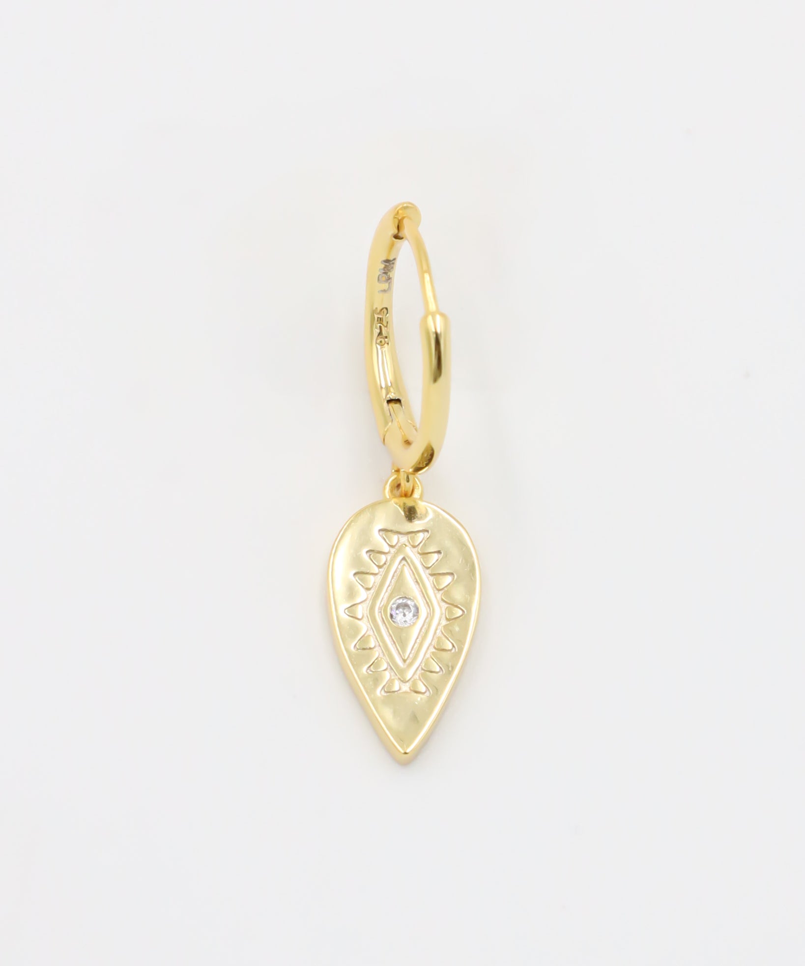 A single gold hoop earring with a hinged clasp and a dangling, ornate, gold heart-shaped charm.