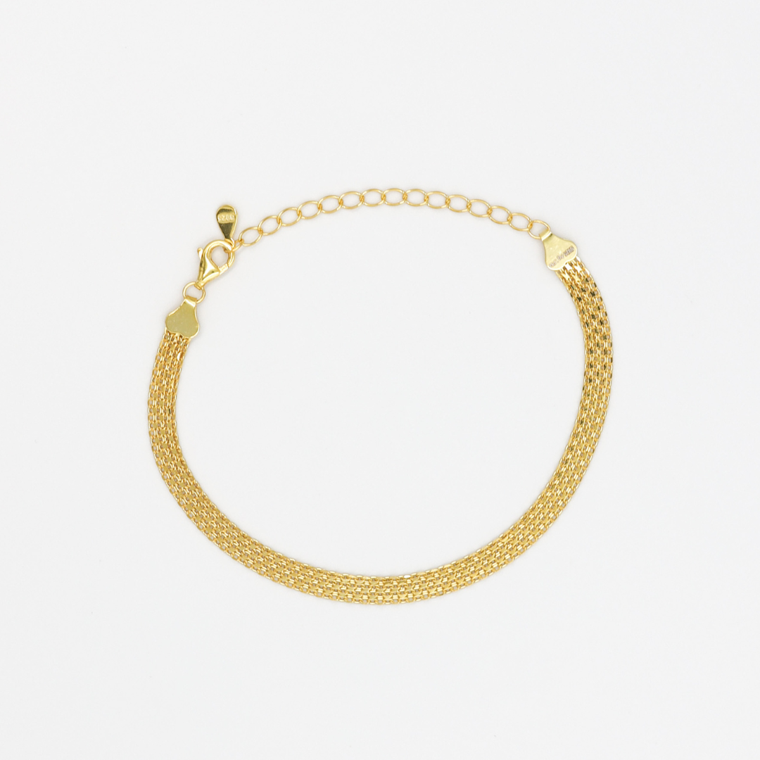 A gold-colored bracelet with a mesh chain design on a white background.