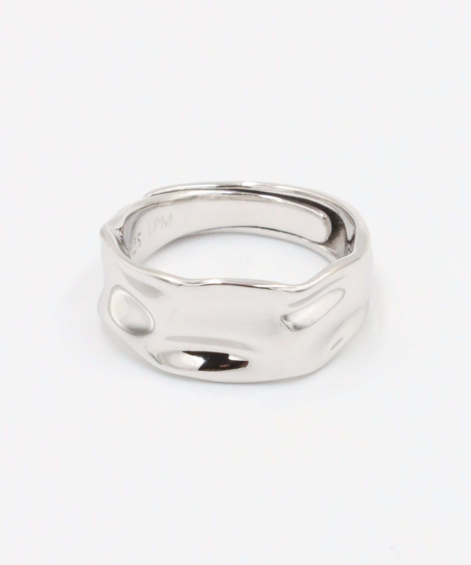 A silver ring with a simple, elegant design on a white background.