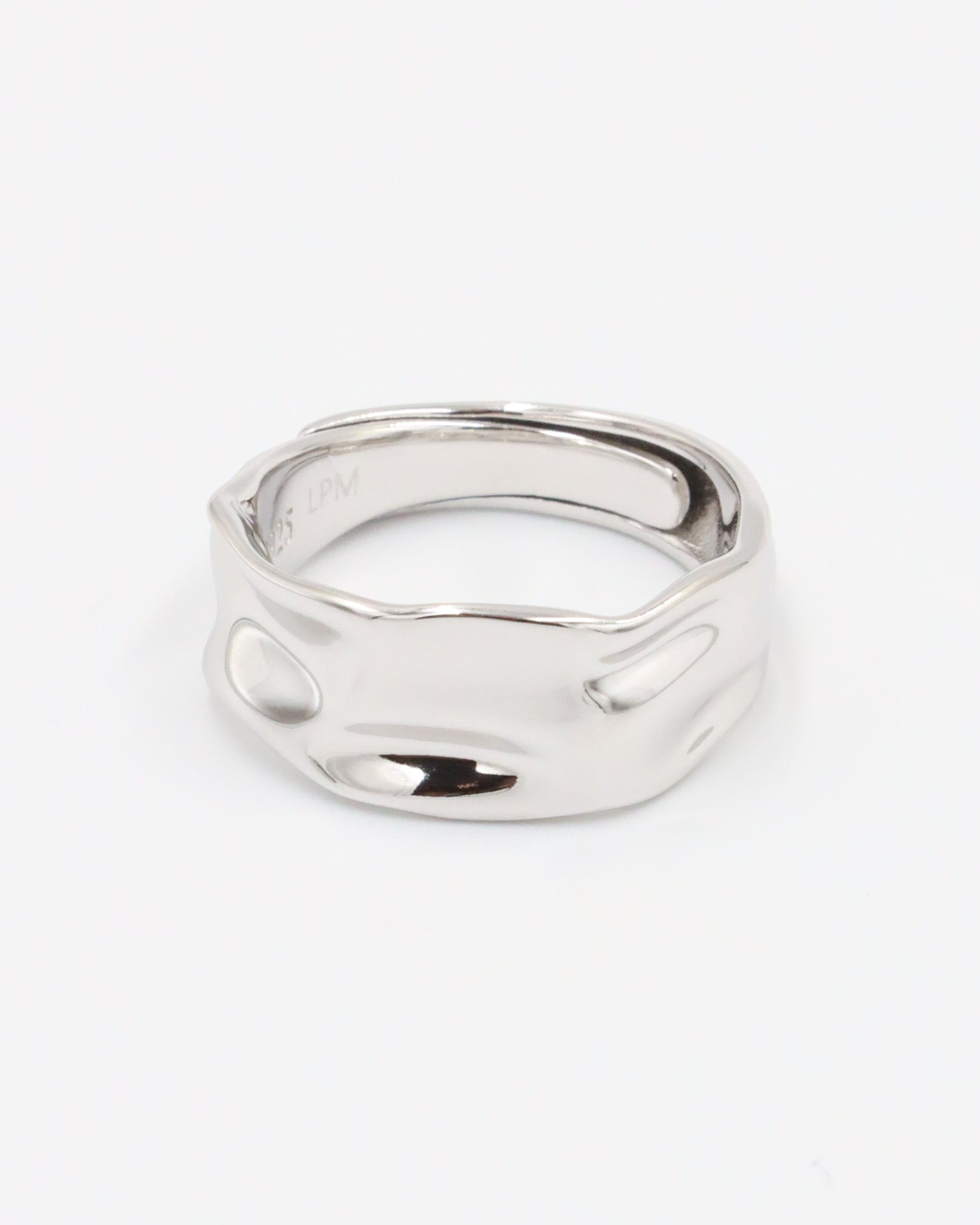 A silver ring with a simple, elegant design on a white background.