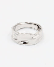A silver ring with a simple, elegant design on a white background.