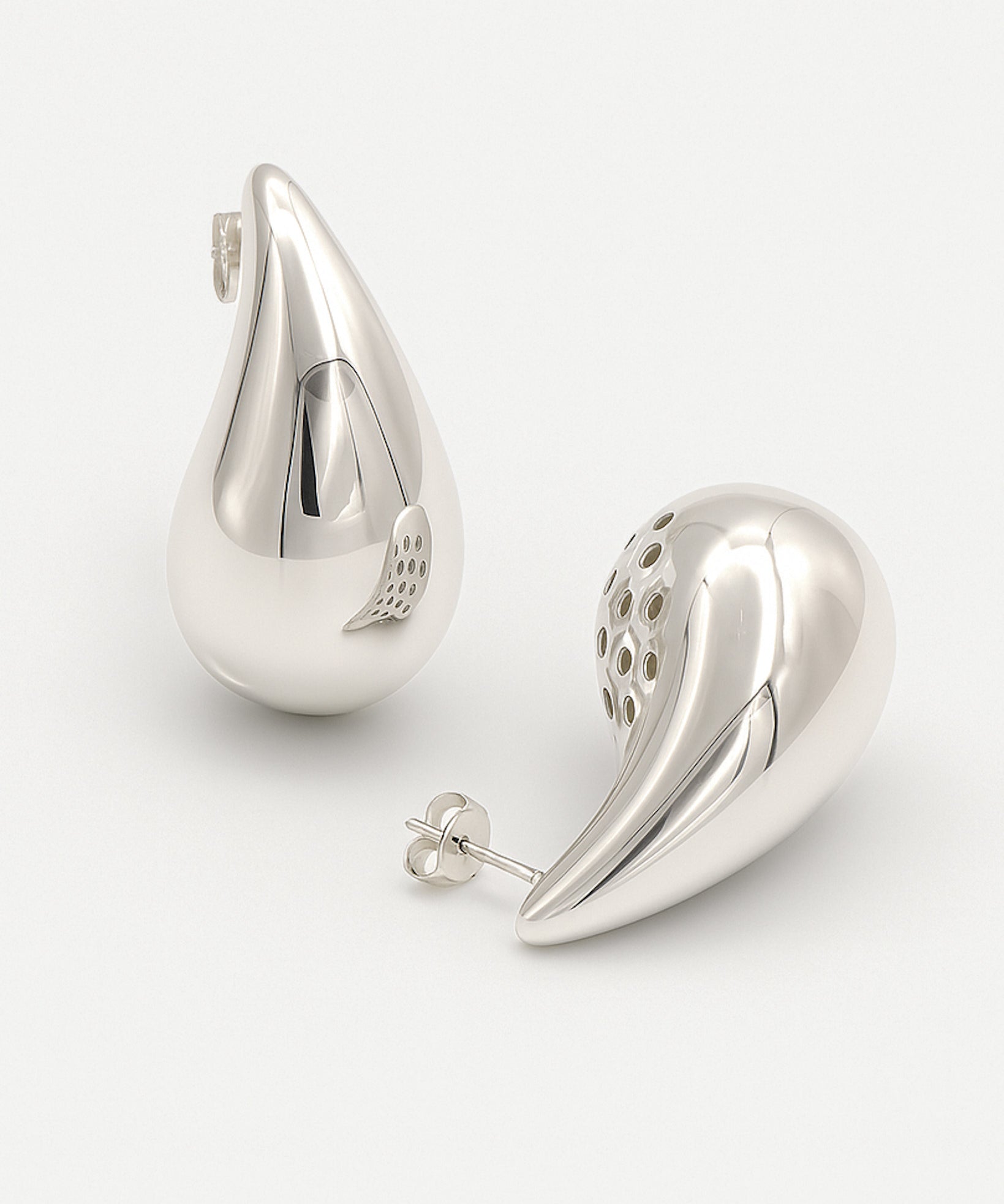 Pair of silver teardrop-shaped earrings on a white background