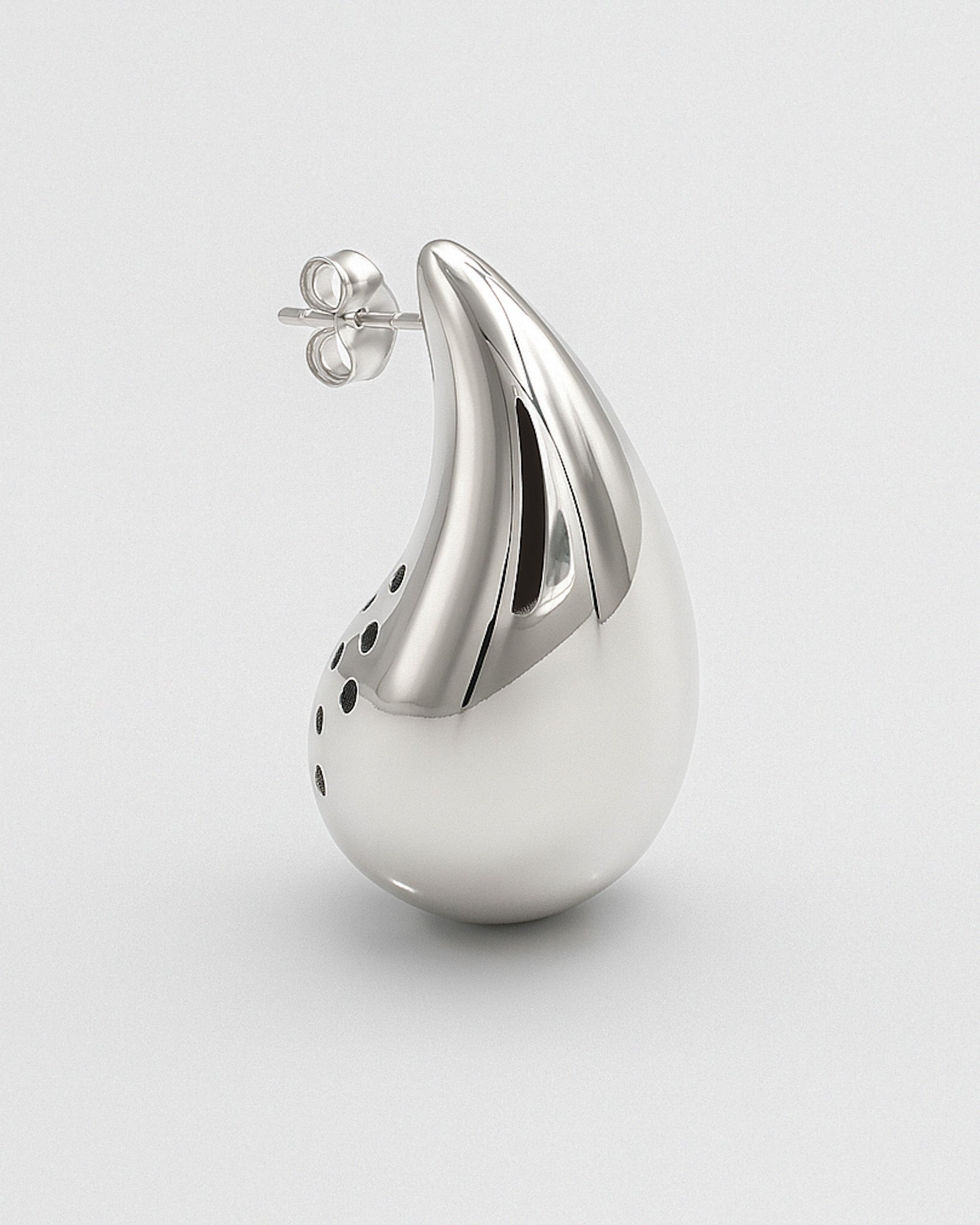 Silver teardrop-shaped earring on a light gray background