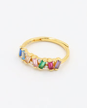 A gold-colored ring with multicolored gemstone accents
