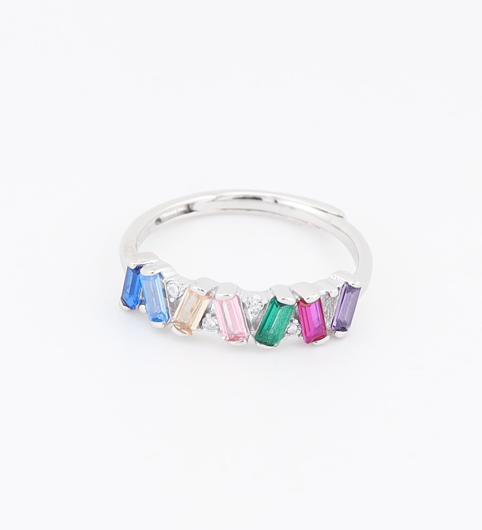 Silver ring with colorful gemstones on a white background