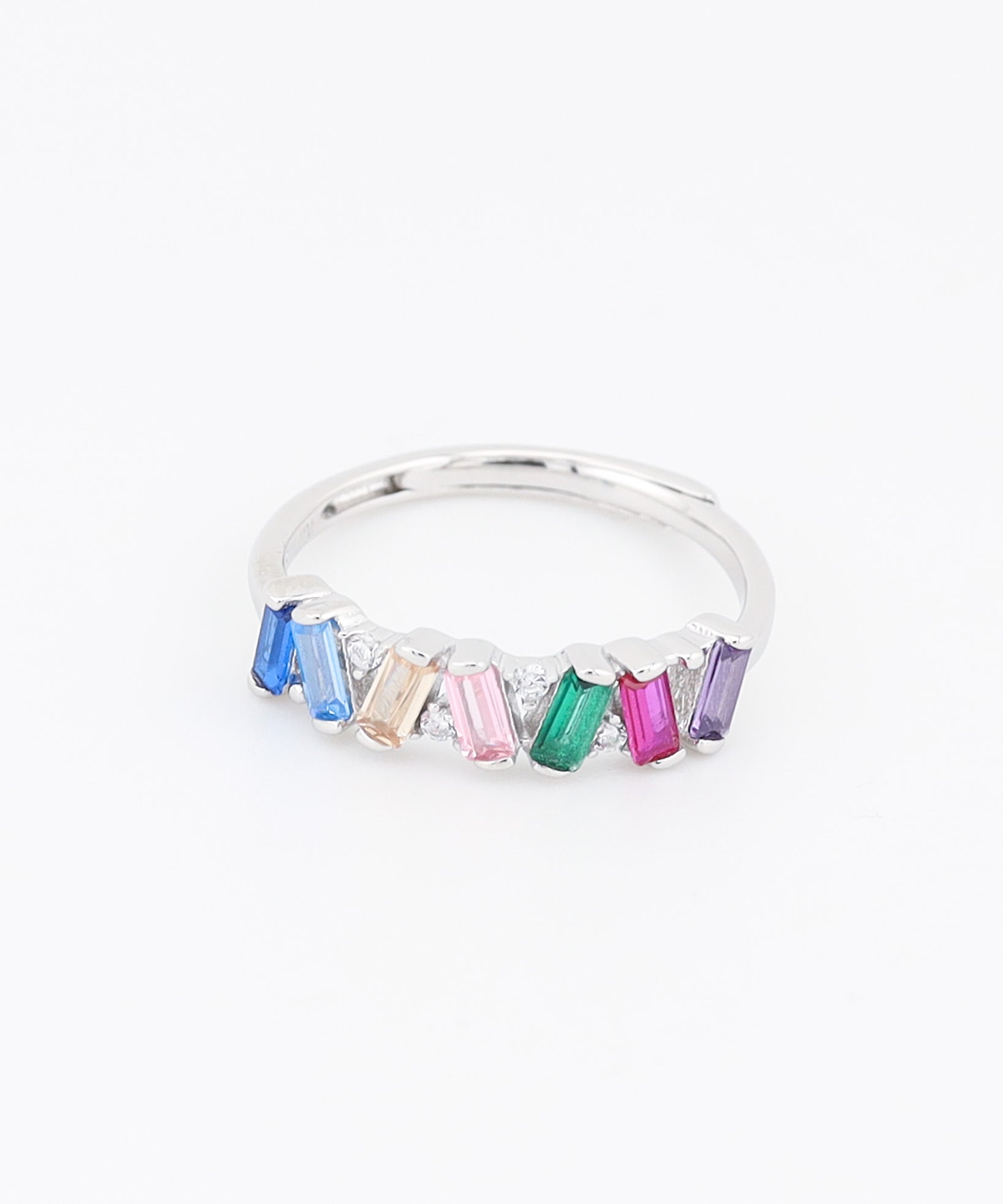 Silver ring with colorful gemstones on a white background