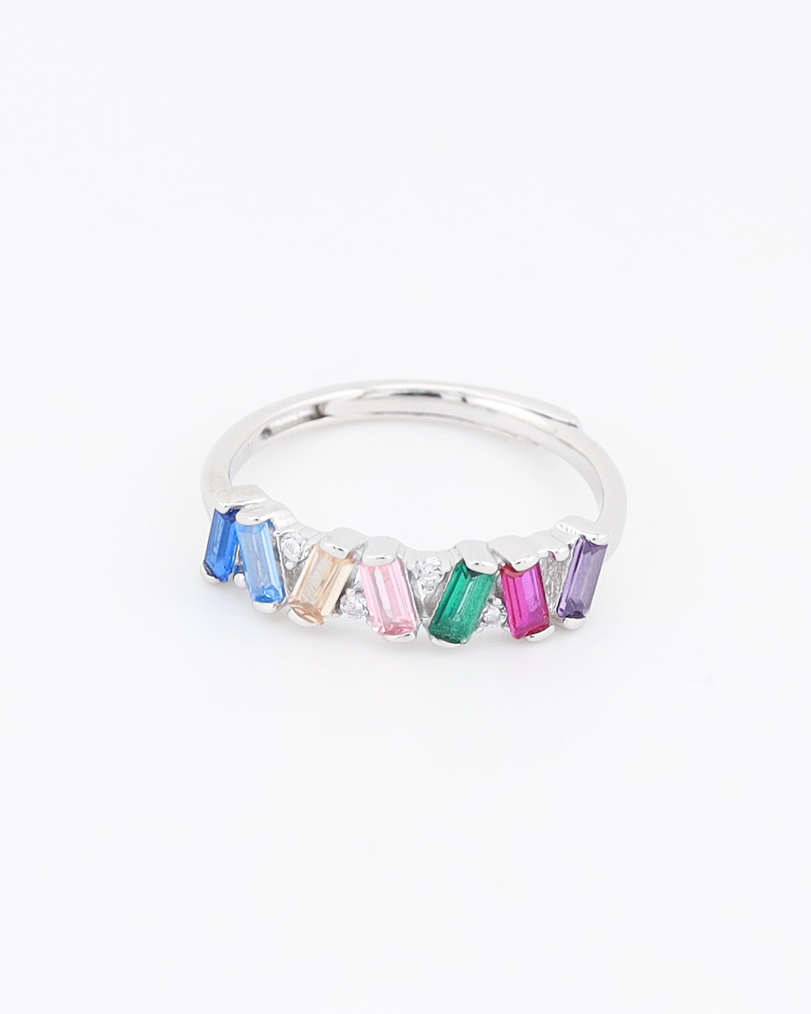 Silver ring with colorful gemstones on a white background