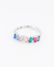 Silver ring with colorful gemstones on a white background