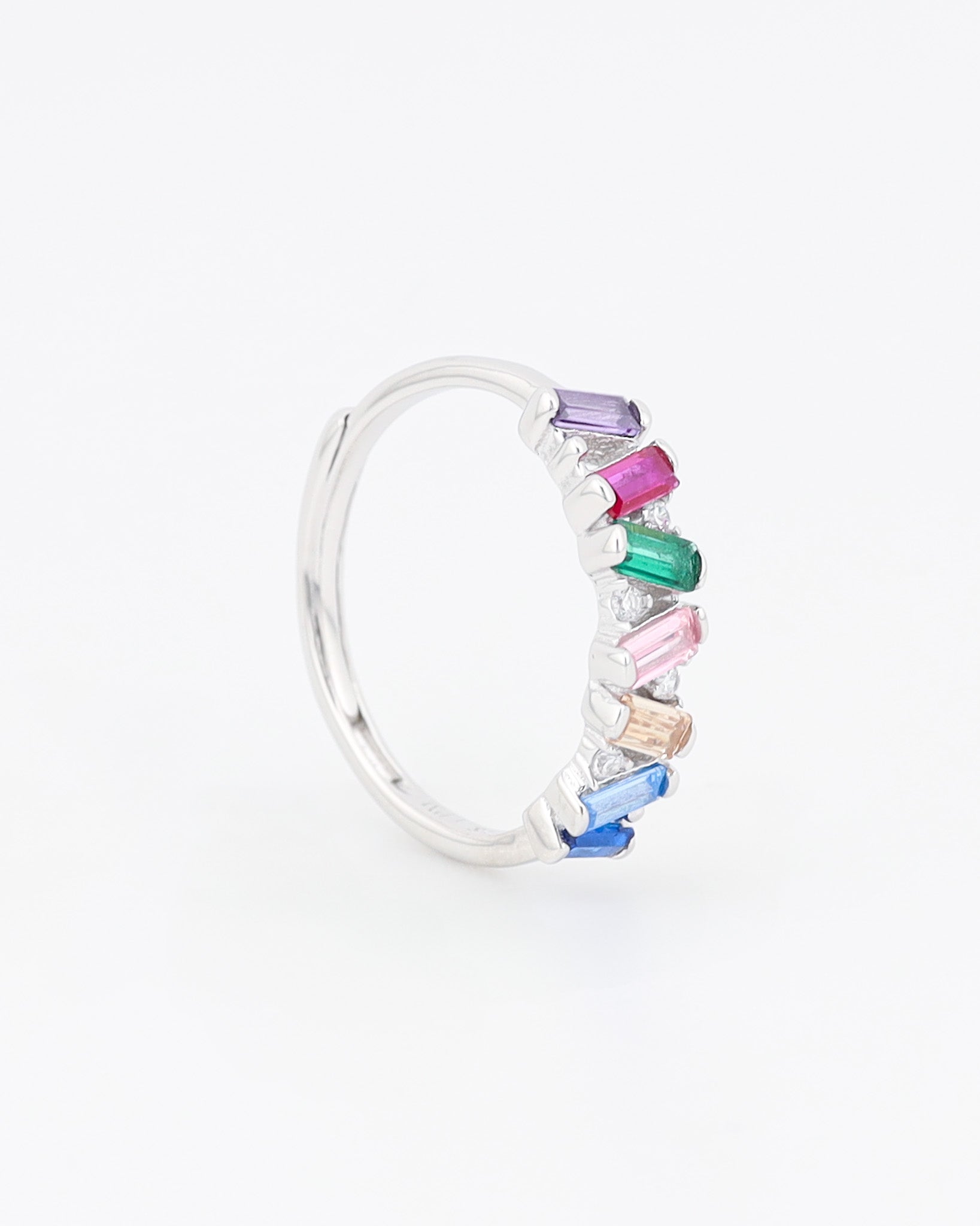 Silver hoop earring with multicolored gemstones on a white background