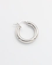 A pair of silver hoop earrings with a latch back closure, displayed against a white background.