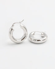 A pair of silver hoop earrings with a latch back closure mechanism, displayed on a white background.