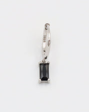 A black and silver colored hoop earring with a hinged clasp.