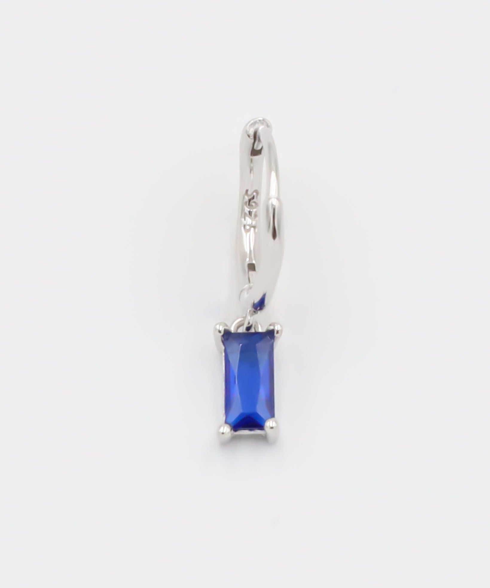 A blue hoop earring with a silver closure mechanism, displayed against a white background.