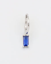 A blue hoop earring with a silver closure mechanism, displayed against a white background.