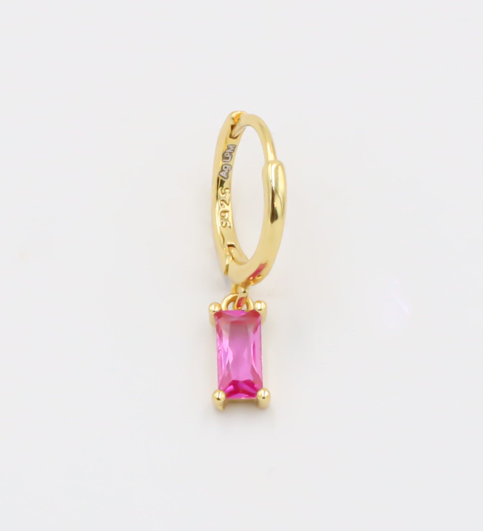 A single pink gemstone earring attached to a gold-colored hoop, presented against a white background.