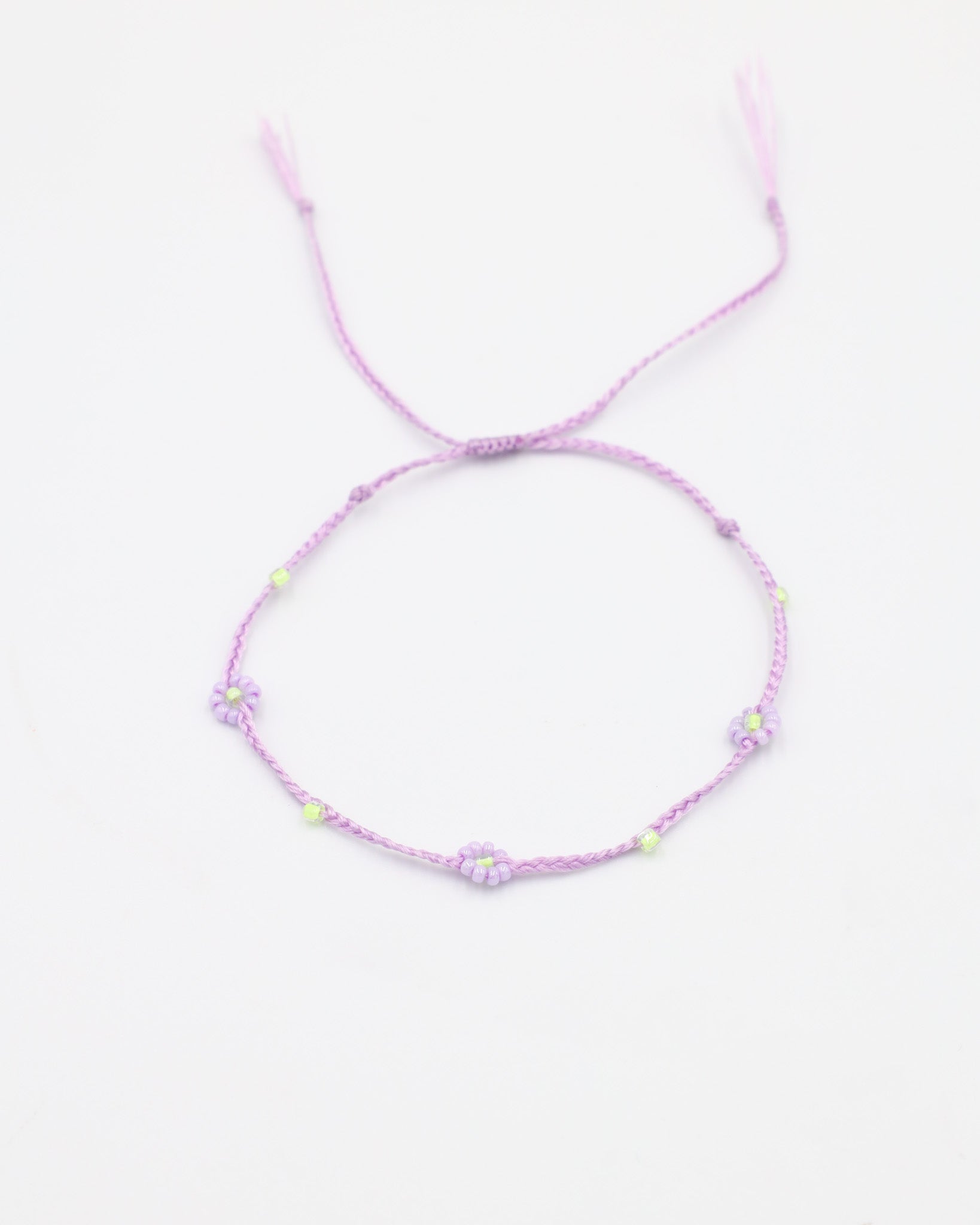 An adjustable gold-colored bracelet featuring a series of round beads and rhinestones, with an emphasis on the flower-shaped design.