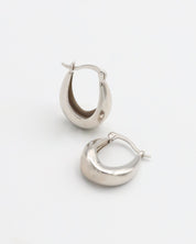 A pair of silver hoop earrings with a latch back closure, displayed against a white background.