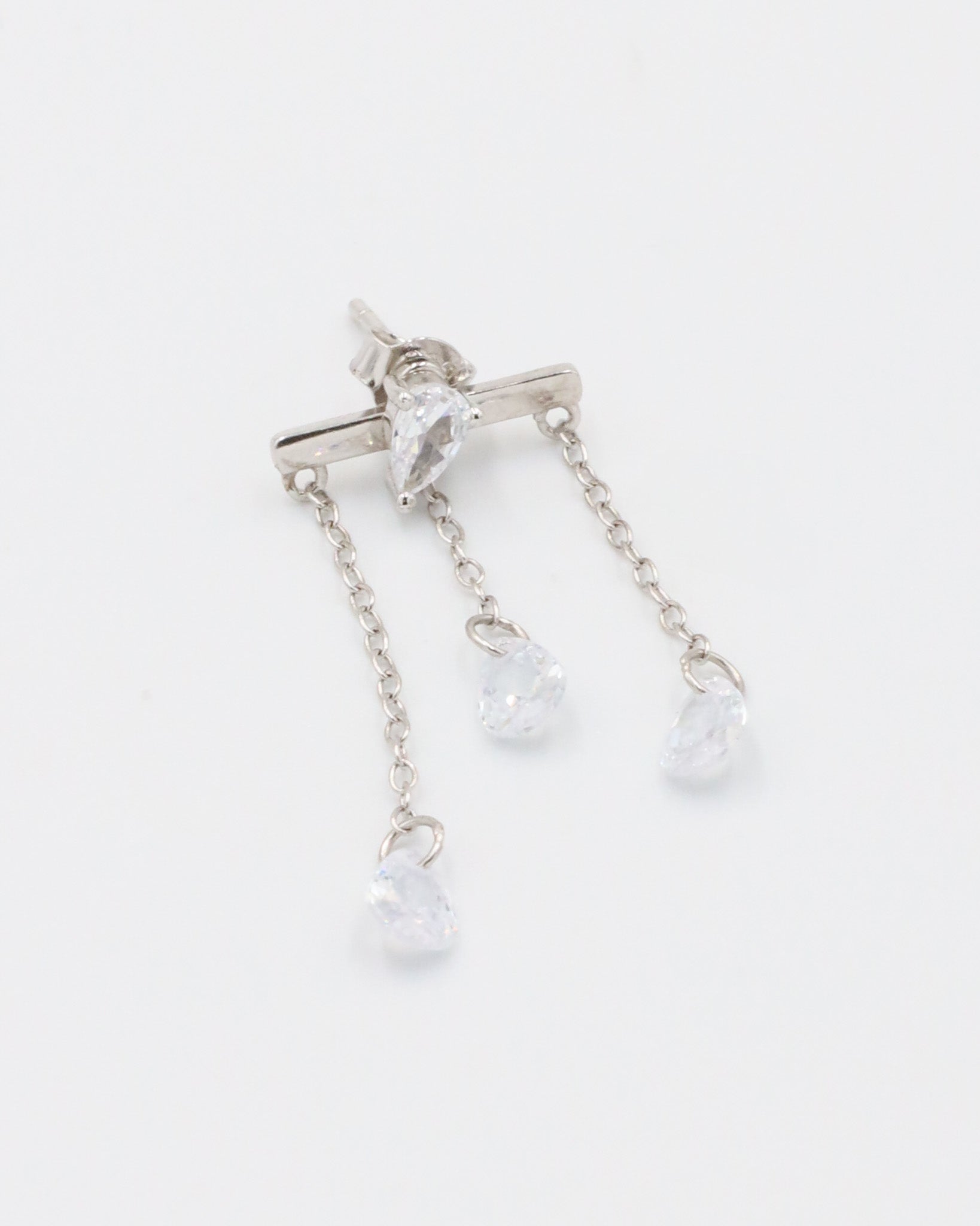 A pair of silver earrings with a stud closure and dangling chain detailed with small clear crystals.