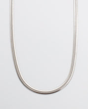 A silver-colored necklace with a metallic texture, displayed against a white background.