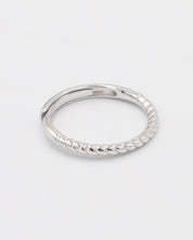 A silver ring with a twisted band design on a white background.