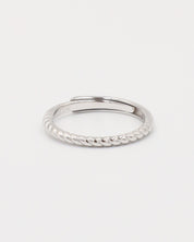 A silver ring with a twisted band design on a white background.