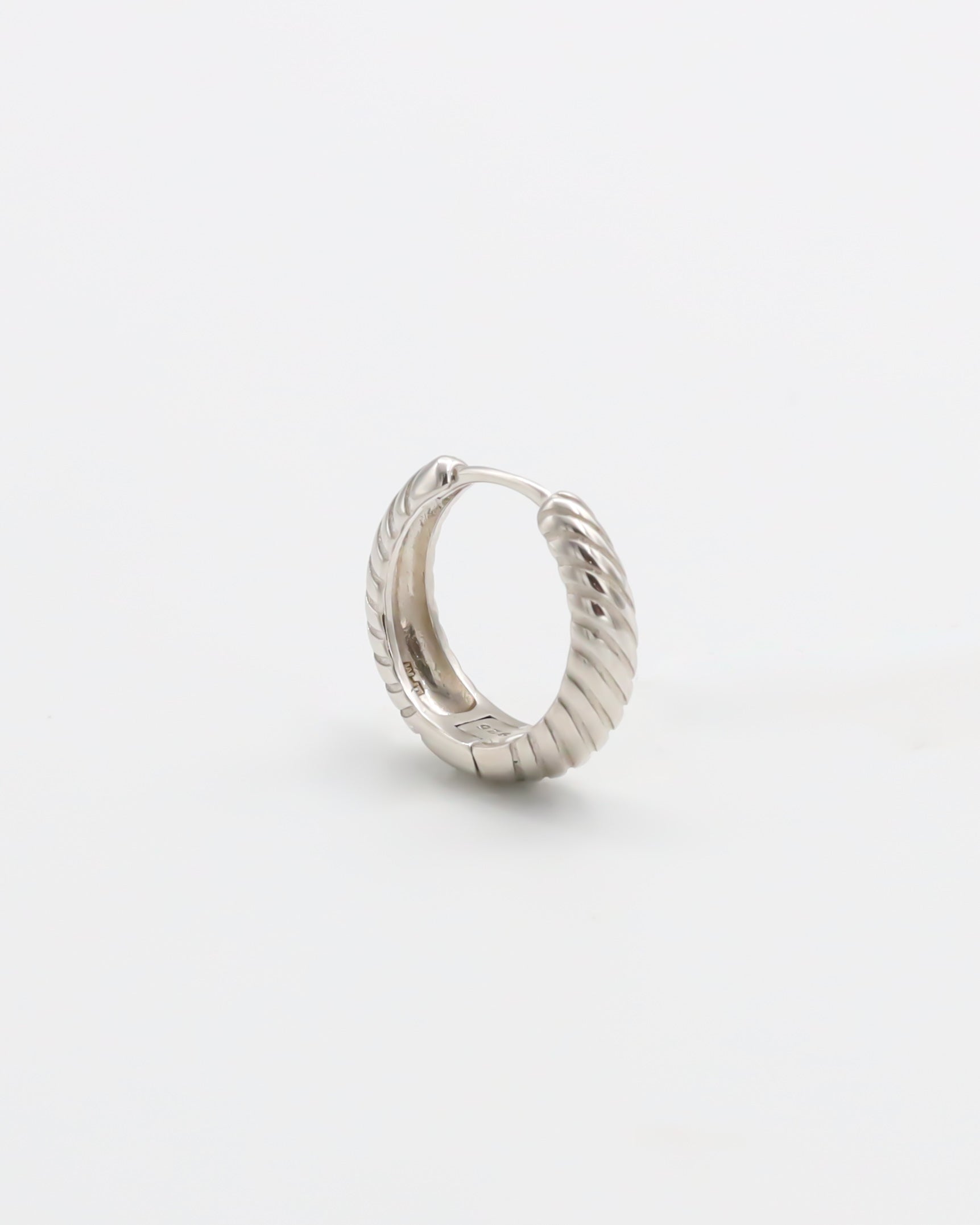 A single silver hoop earring with a hinged clasp, displayed against a white background.