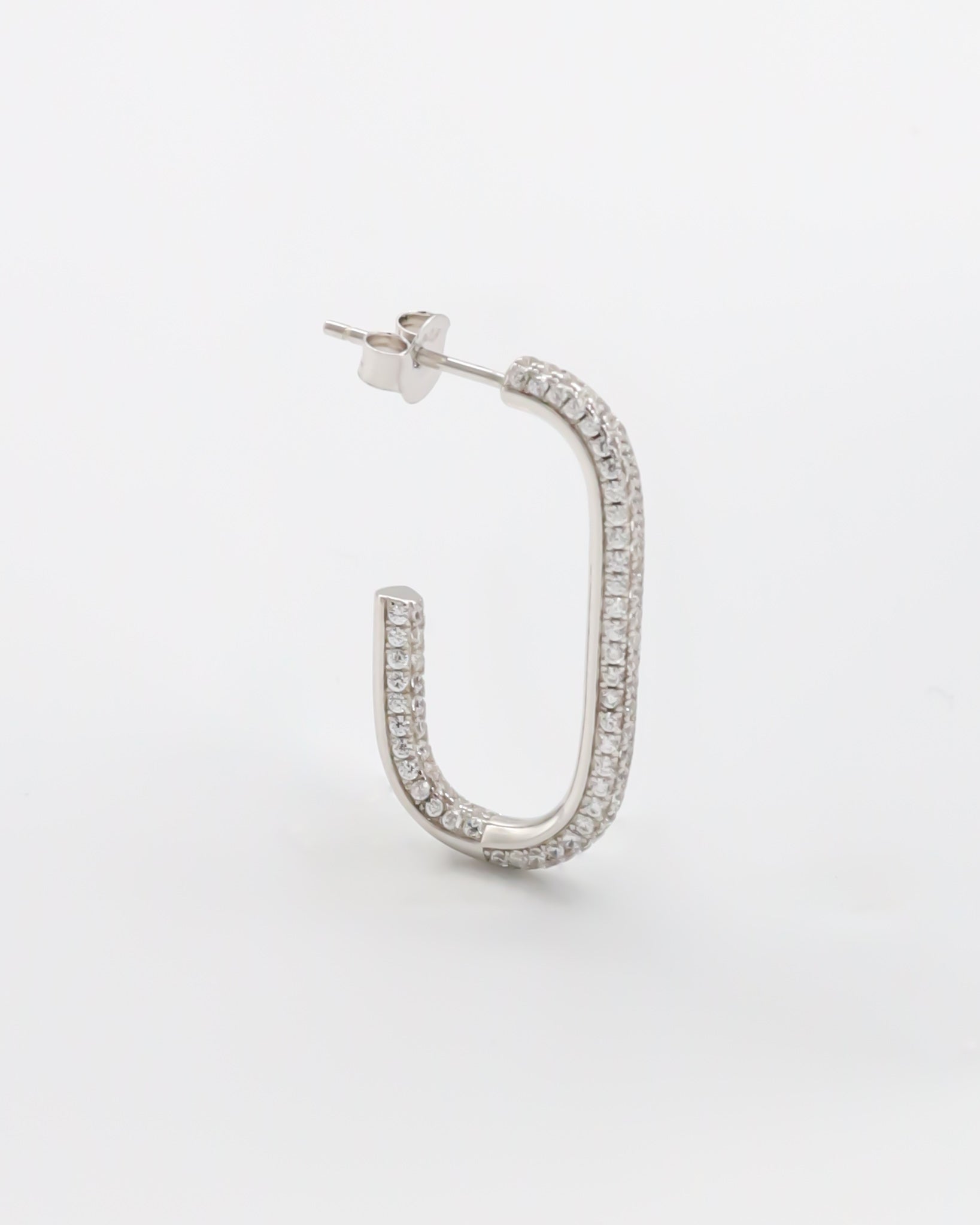 A single silver-colored hoop earring with a butterfly clasp closure, displayed against a white background.