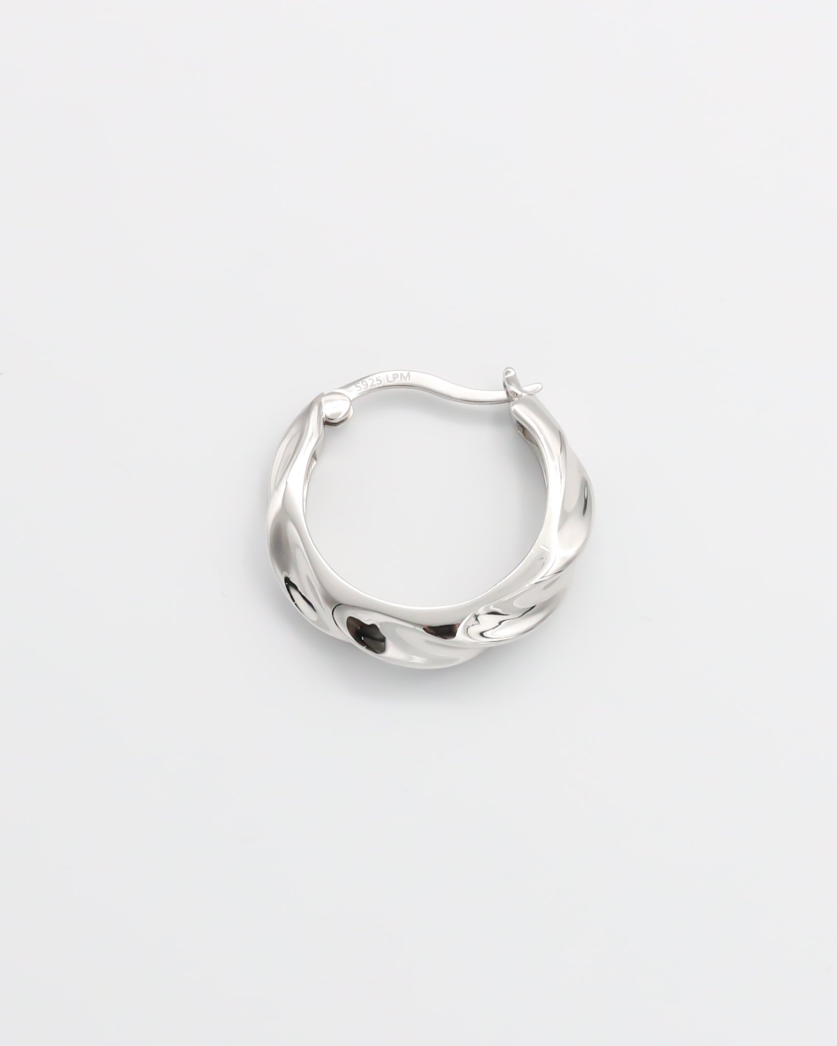 A pair of silver hoop earrings with a latch back closure, displayed on a white background.