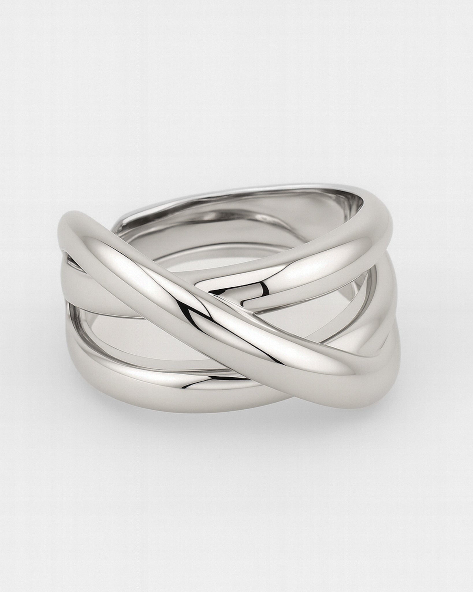 Silver ring with a braided design on a white background