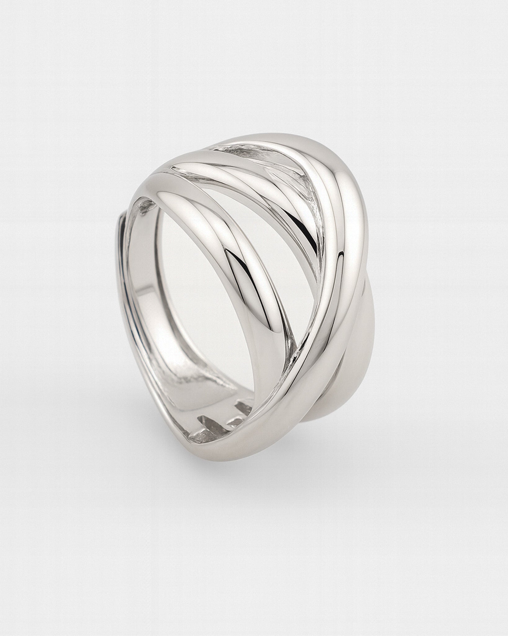 Silver ring with a wavy design on a white background